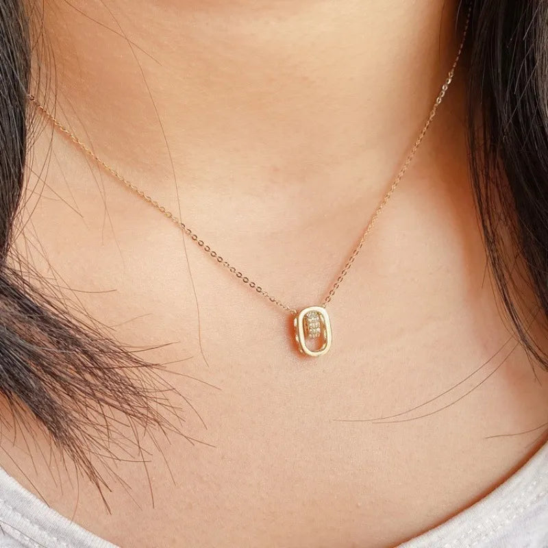 18k gold plated rectangular pendant necklace with textured details on woman's neck