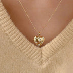 18K gold plated heart pendant necklace with cubic zirconia, worn on a cream sweater