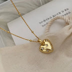18K gold plated heart pendant necklace with cubic zirconia accents on a textured chain