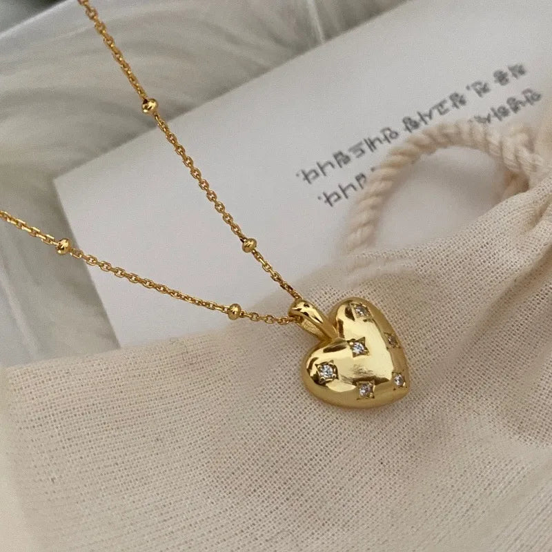 18K gold plated heart pendant necklace with cubic zirconia accents on a textured chain