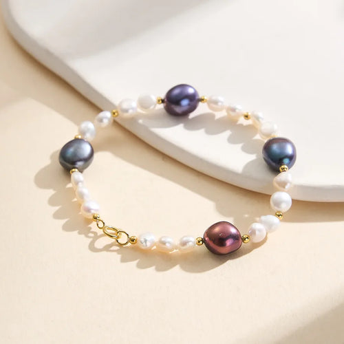 Elegant bracelet with multicolor pearls, gold accents, and white freshwater pearls